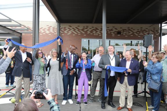 Mayor Yemi and other important people who were involved in the Senior Center renovation celebrating after the ribbon was cut.