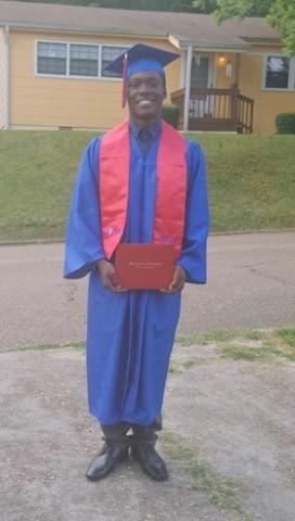 Jesse Schiele III wearing a graduation cap and gown