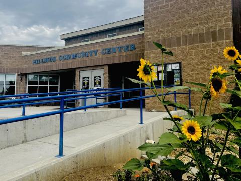 Hillside Community Center entrance behind sunflowers