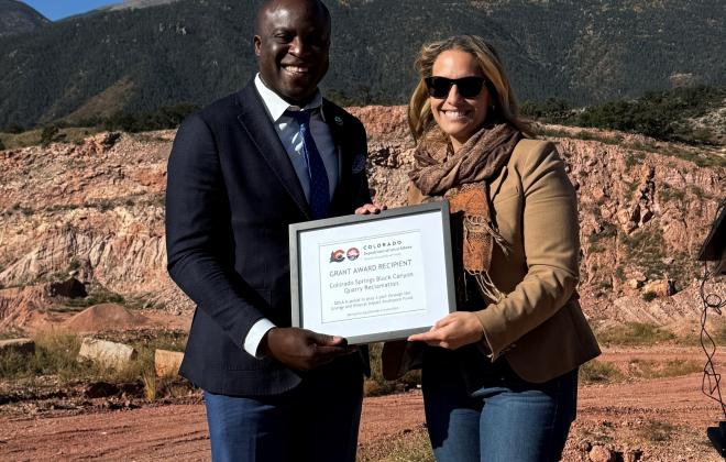 Mayor Yemi accepts a framed grant from DOLA at the Black Canyon Quarry.